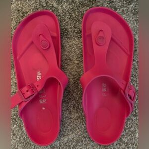Hot pink Birkenstock sandals.